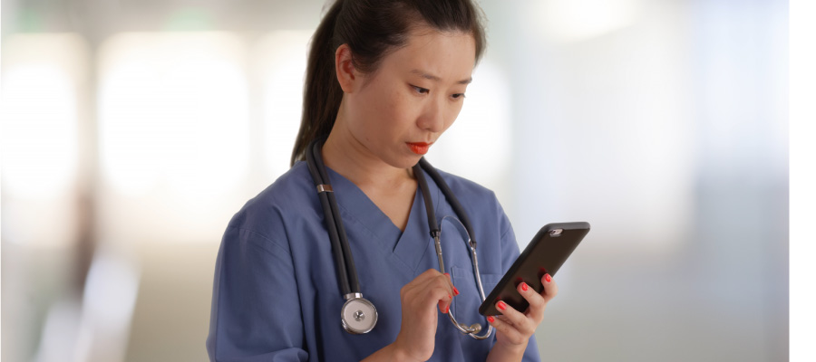 Healthcare worker holding up phone with Epic Rover EHR on the screen