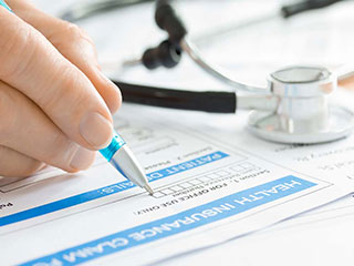 A healthcare worker filling out a form